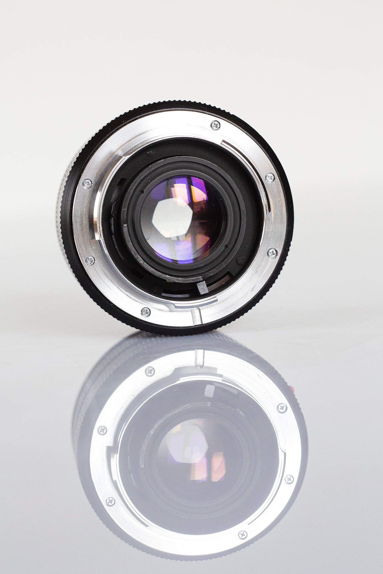 A fully serviced vintage lens, showing clear optics and aperture blades. 